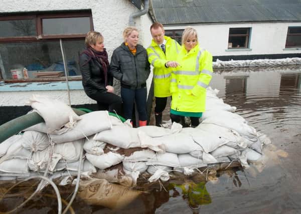 Michelle O'Neill (Minister of Agriculture and Rural Development)  and David Porter (Cheif Executive Rivers Agency) today viewed the flooding at Meghan Ni Raifeartaigh's home at Derryall Portadown. Also in the photograph is Meghan's mum Cathy Rafferty.