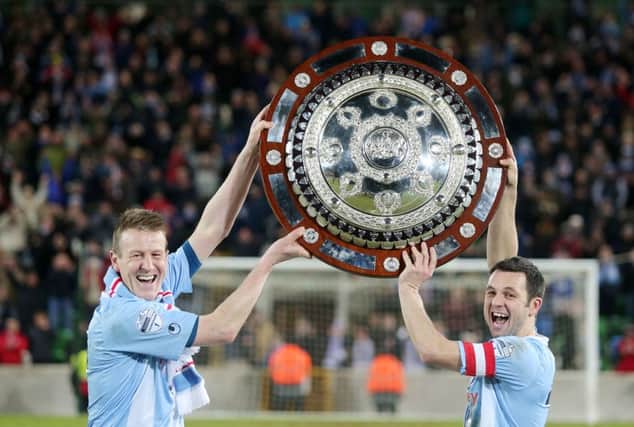 Ballymena United captain Jim Ervin (right) and Allan Jenkins lift the County Antrim Shield on Tuesday night