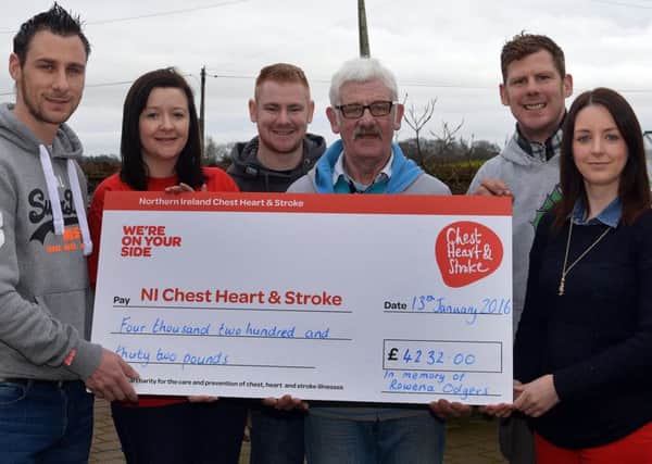Jonnie Odgers, left, and family, Michael, John, Red and Leeanne, hand over a cheque for Â£4,232  to Carla Smyth, second left, of Chest, Heart and Stroke. INPT02-210.