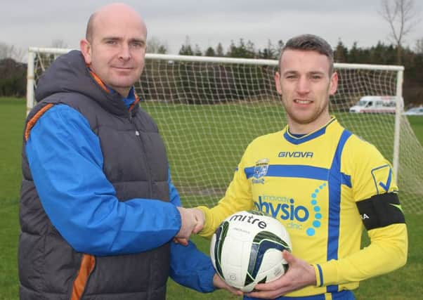 Ian Walker from WE Stitch pictured presenting a match ball to Matty Hamilton, Roe Rovers Captain.