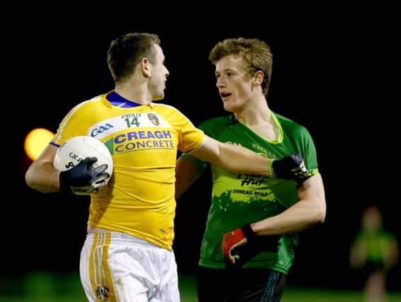 Brendan Rogers, in action for Queen's against Antrim's Sean Burke, will come back into contention for Derry in this weekend's McKenna Cup semi-final aginst Cavan.
