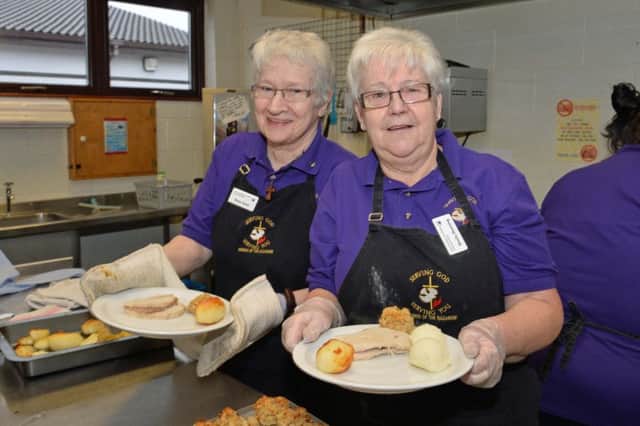 Rosie Gault and Sheila Dunning prepare the dinners at the Good Morning Carrickfergus annual lunch in the Church of the Nazarene hall. INCT 02-010-PSB