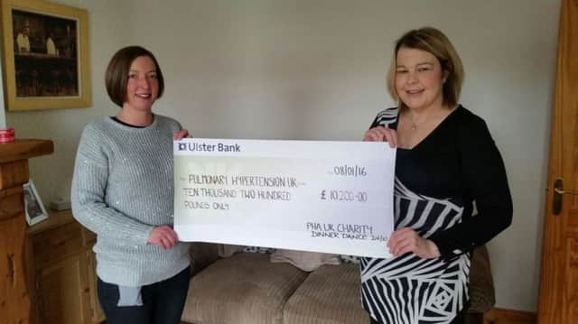 Ally Whan from Dromara and Alana Smyth from Ballynahinch with a cheque for Â£10,200 raised for the Pulmonary Hypertension Association UK.