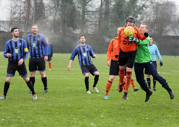 Waveney Swifts' goalkeeper thwarts a Holywell attack in one of the few Saturday Morning League game to beat the conditions on Saturday. INBT 04-824H