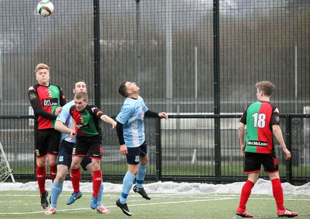 Ballymena United and Glentoran players in an aerial contest during Saturday's Harry Cavan Youth Cup quarter-final. INBT 04-831H