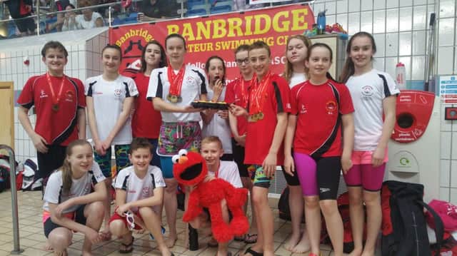 Banbridge ASC swimmers show off their spoils after another successful day's swimming in Lisburn.