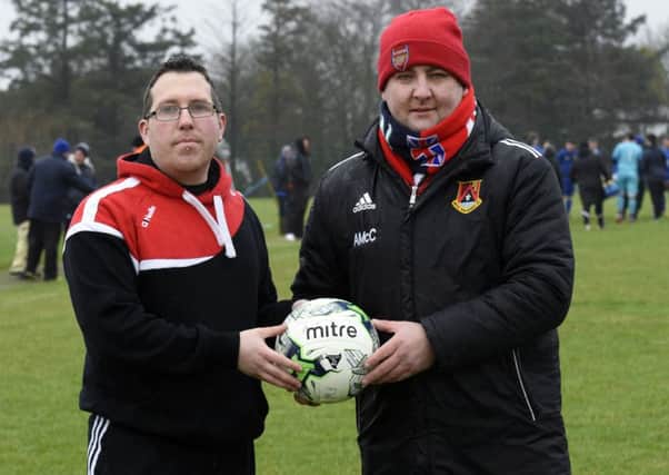 Brian Coyle, left, of Brian Coyle Sports Massage, handing over a sponsored match ball to Foyle Wanderers manager Andy McClintock. INLS0316-130KM
