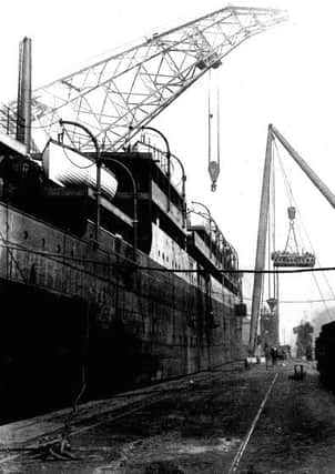 The bell being fitted on the White Star Liner the Laurentic during construction in 1908.