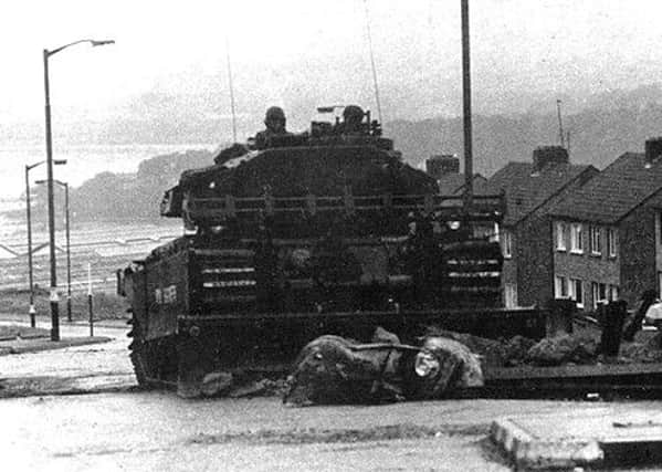 A Centurion tank fitted with a bulldozer blade makes its way up Eastway in Creggan, during Operation Motorman in July, 1972.