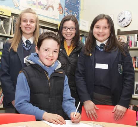 SSSSHH. Pictured in the Libarary during Ballymoney  High School's Open Night on Monday night are pupils, Katie and Rachel along with Kathy Murray and her son Josh.INBM3-16 001SC.