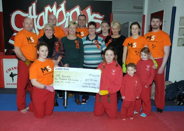 Helen Wilson, Liz Graham, Jenny Bindley and Linda Erskine from Larne's MS Society accept a Â£2,381 cheque from members of Larne's Champion's Kick Boxing Academy, the money was raised by a white collared Boxing Night. INLT 03-214-AM