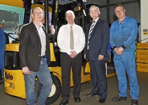 Pictured with the new forklift truck are, from left: Rod Hogg, logistics manager, Oxfam; Neil Turkington, trainer, Yale; Jonathan Bell MLA and Yale production operator Eddie Smart.
