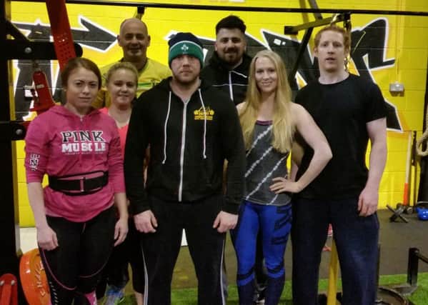 Billy Hutchison, Derry Powerlifting Club coach, pictured with some of the club's members during a training session last week.
