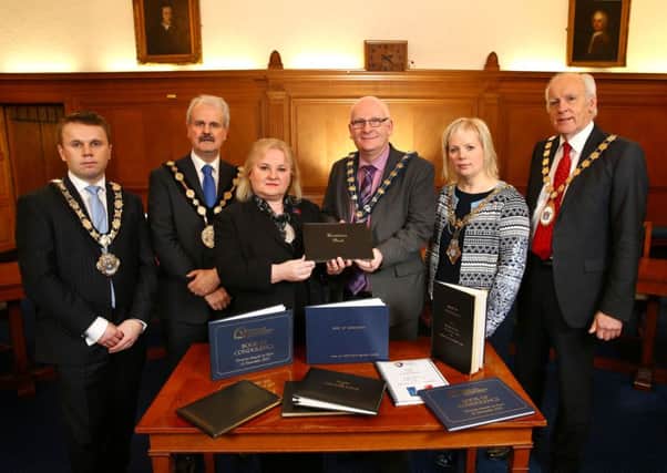 Mayor Thomas Hogg (left) with other local civic leaders handing over the Books of Condolence to French Honorary Consul, Regine McCullough (third from left). INNT 03-504CON