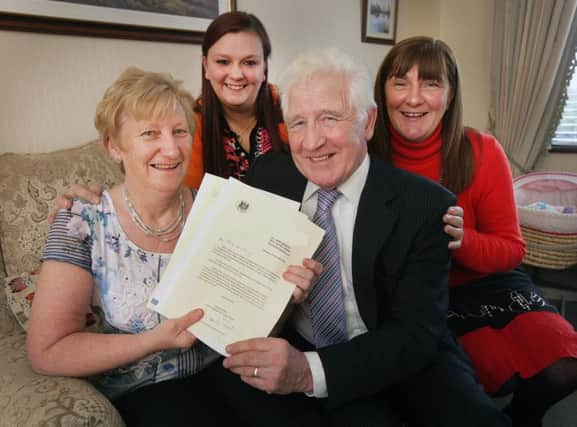 Margaret and Husband John are pictured with Beverley Ringland from Belfast Trust Social Services and behind them is Kirsty, Margaret and John's foster daughter.