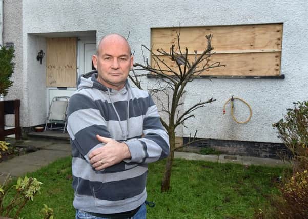 Defiant...Tony Conway outside his house which was attacked at the weekend. INLM03-210.