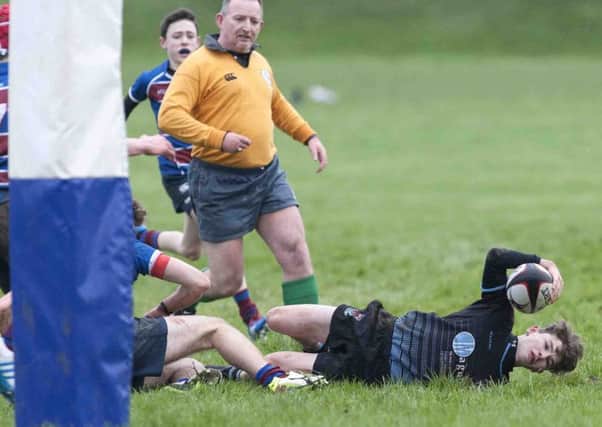 Portadown College's Dylan Nelson scoring the only try of the Medallion Shield match.