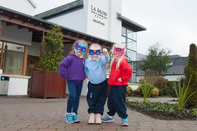 Reminding you to cast vote for your family's superheroes at the Family First Awards are (l-r) Beth Greer from Little Kingdom Kids in Bangor, Tianna Taggart from Peter's Patch Day Nursery in Hillsborough and Izzy McKelvey, from Bella Bambinos in Dromore. Pic by Collette O'Neill