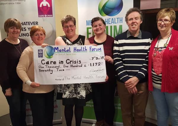 Elaine Fogarty, third from left, presents a cheque to Karen Moore, second from left, Care in Crisis.  Also pictured are forum members Caroline Ferguson, Shauna McCausland, Laurence Healey and Linda Gilpin. INPT04-001