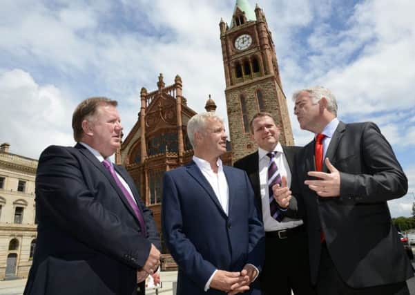Enterprise, Trade and Investment Minister Jonathan Bell MLA, right, chatting to Bill Thompson, second from left, of One Source Virtual, at the jobs announcement in the Guildhall back in July 2015. Included are Bill Scott, left, and Derek Andrews, of Invest NI. DER2715-108KM