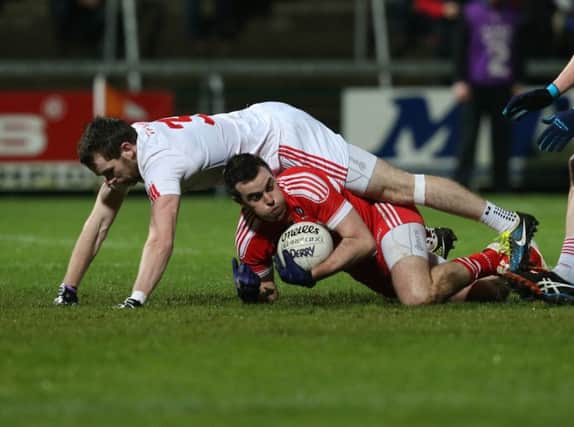 Cailean O'Boyle is felled by the challenge of Tyrone's Ronan McNamee for Derry's first half penalty in the Athletic Grounds on Saturday. (
Picture by Andrew Paton/Presseye.com)