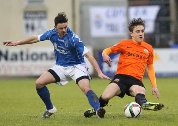 Joel Cooper of Glenavon and Dale Montgomery of Dungannon 
in action at Stangmore.