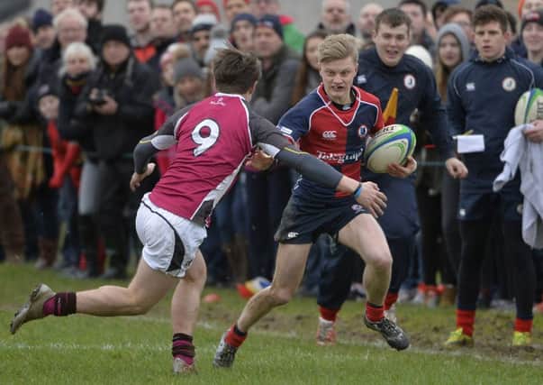 Ballyclare's Mark Crowe  in action with RS Dungannon's Adam Cranston