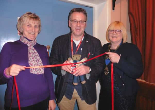 Glarryford WI President Margaret Ferguson preparing to cut the red ribbon and declare their Bring & Buy sale officially open. (Submitted Picture)