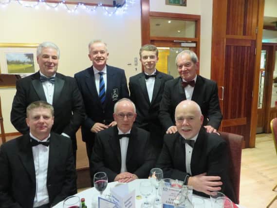 Dunmurry Captain Colin Riddel (second left back row) with his guests Ken Cathcart, Matthew Riddell, Trevor Davidson, David Curry, Michael Jackson and Stephen Pendleton at the Members Annual Dinner.