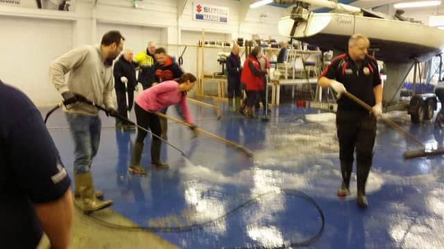 Volunteers from Lough Neagh Rescue help with a major clean up at Custom Covers at Kinnego Marina which was badly flooded recently.