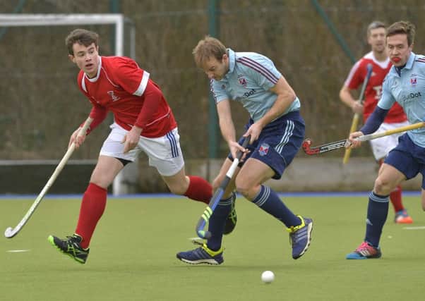 Portadown men's firsts' Robert Scott (left) attempting to win back for possession last weekend against Belfast Harlequins.