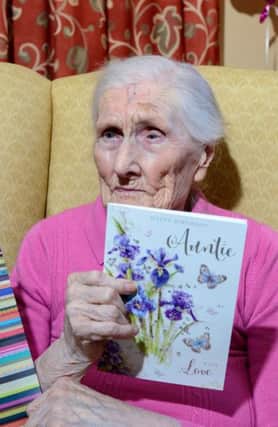 Mary Shaw a resident of Moneymore Care Home holds one of the many birthday cards she received when she celebrated her 101st birthday last Wednesday.INMM0516-323