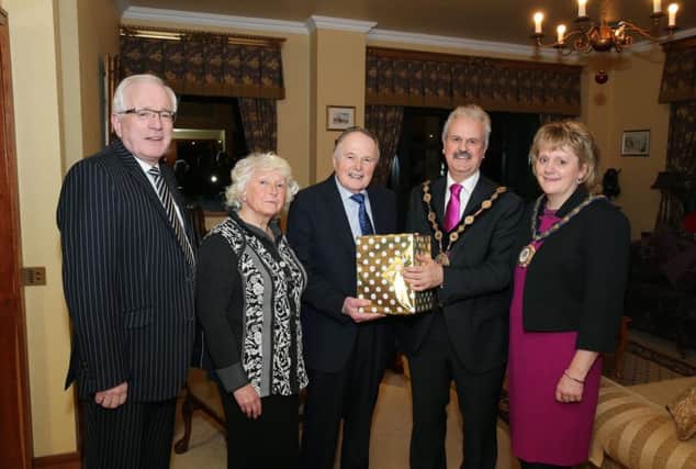 Mayor of Lisburn and Castlereagh City Council Councillor Thomas Beckett and the Mayoress Mrs Linda Beckett present a gift to Dr. John and Eunice Douglas at the recent celebration event in Lagan Valley Island. Also pictured are Alderman Allan Ewart who attended the event. Picture by Kelvin Boyes / Press Eye.