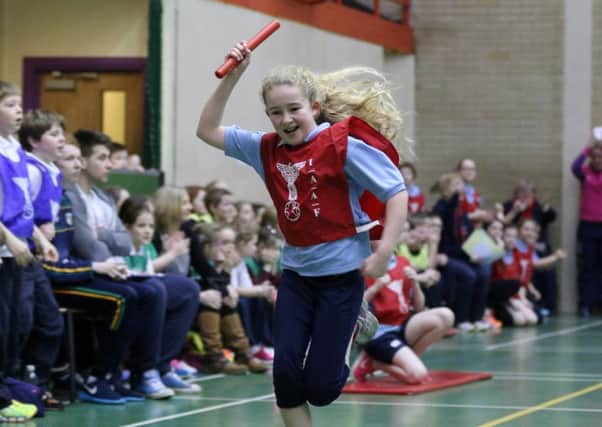 Georgina Cherry of Clough Primary School celebrates winning her race at the Fun in Athletics Team Challenge at Northern Regional College Farm Lodge Campus. INBT 05-176CS