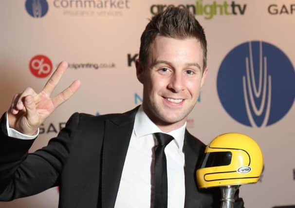 Irish Motorcyclist of the Year winner Jonathan Rea celebrates with the Joey Dunlop Trophy at the Cornmarket Motorcycle Awards  in Belfast on Friday night. PICTURE BY STEPHEN DAVISON