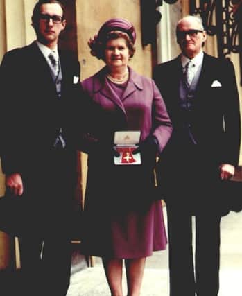 Mrs Holmes receiving her OBE at Buckingham Palace in 1978 with her son James and husband Harold.