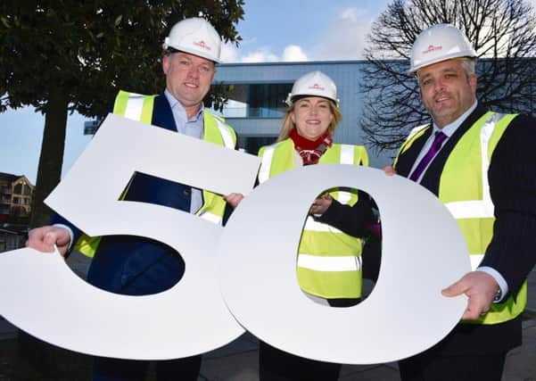Stephen Thornton (Managing Director), Jenny Neeson (Finance Director) and Kenny Smyth (General Manager) from Thorntons who have announced a major recruitment and investment programme as part of their 50th year in business. In the background is the Belfast Waterfront Hall's new extension where Thornton installed cladding and soffits.