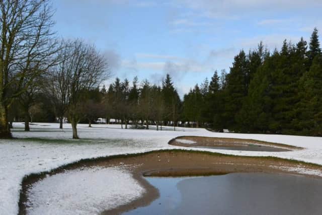 The snow covered course and flooded bunkers.