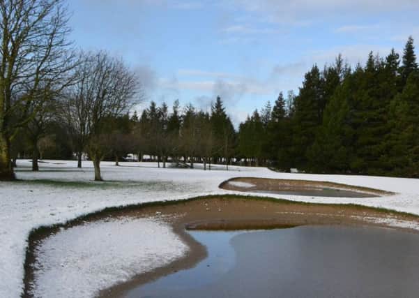 The snow covered course and flooded bunkers.