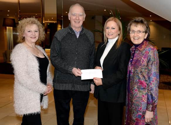 At the Ramada Hotel Belfast last Thursday Evening Joan Cunningham
Saintfield Christmas Charity Ride Organiser presents a cheque to Ian
and Phyllis Hasson (Rock Ministries N.I. Trust). Also included is
Lorraine Johnston.