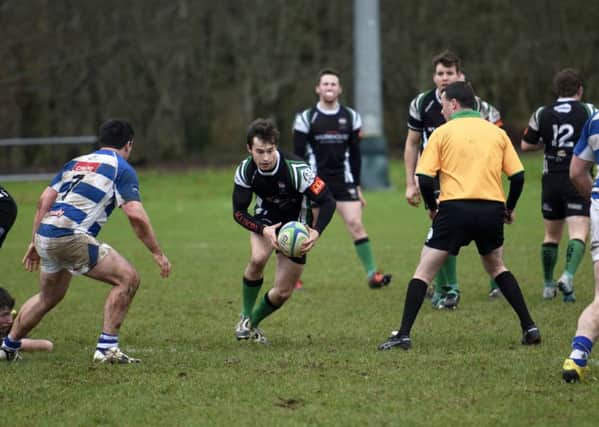 City of Derry scrum-half Simon Logue probes for a gap in the Dungannon lines. DER0616-104KM