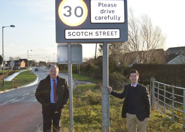 MLA Sydney Anderson and Councillor Jonathan Buckley at the new speed limit sign. INPT05-0035
