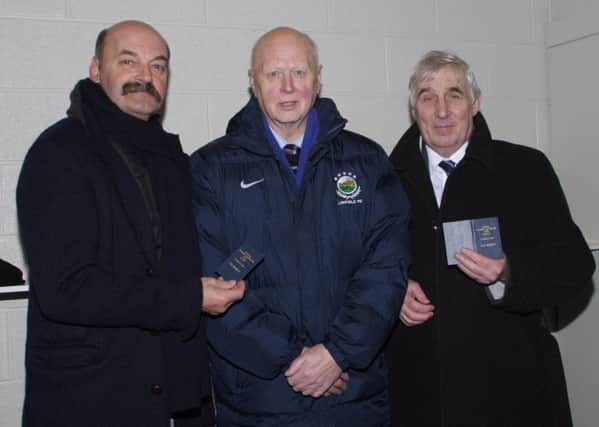 Lisburn man Eric Bowyer (right) with his Linfield Football Club Life Membership ticket presented to him at Windsor Park on Saturday by Linfield Chairman Jim Kerr. Peter Rafferty, left, another iconic Linfield player, also received Life Membership status. Eric, who lives off the Belsize Road, was Linfield captain in the 1960s and 1970s and manager in the early 1990s.