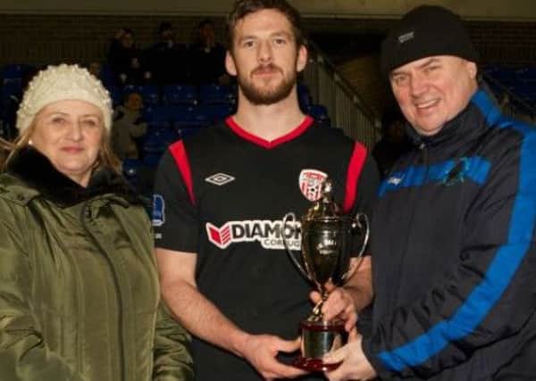 Rebecca Kee and her son Paul presents Derry City skipper Ryan McBride with the Billy Kee Memorial Cup, after they defeated Institute last year.