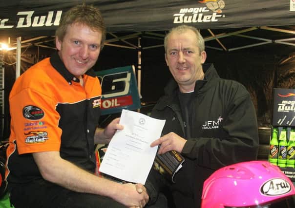 Mid Antrim Clerk of the Course Davy McCartney, right, accepts Davy Morgan's race entry at the bike show. Picture: Roy Adams.