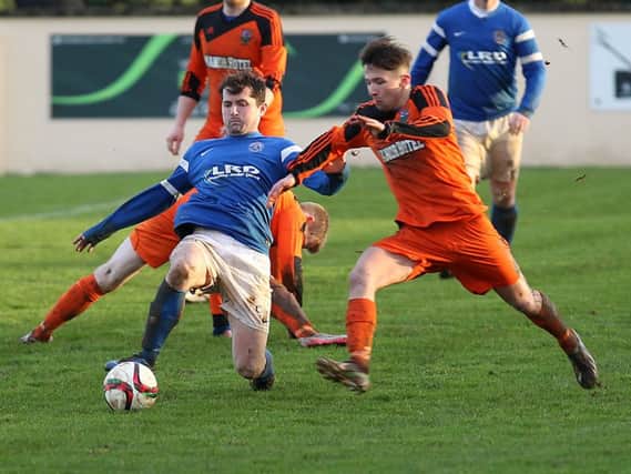 Limavady United midfielder Gareth Tommons tussles with Glebe Rangers' Daniel Brown during Saturday's game. INLV0616-532KDR