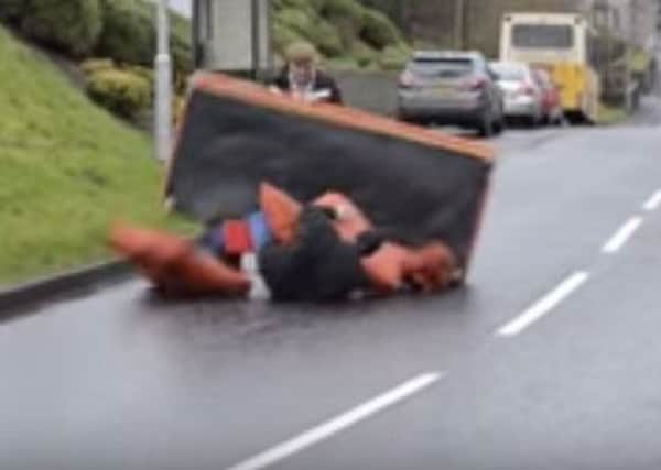 Tyrone men struggle with novel approach to moving a sofa