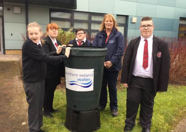 Jane Jackson, Environmental Education Manager at NI Water, with pupils from Jordanstown School and their recently delivered waterbutt. INNT 06-511CON