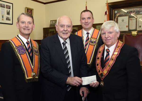 James Hetherington, right, City Grand Master, City of Londonderry Grand Orange Lodge, pictured handing over a cheque for Â£500.00 to Jack Glenn, of the Foyle Branch of Parkinsons UK, at their annual election of officers in the Apprentice Boys Memorial Hall on Saturday. Included are Alderman Maurice Devenney, Deputy City Grand Master, and William Wray, City Grand Treasurer. INLS0616-119KM