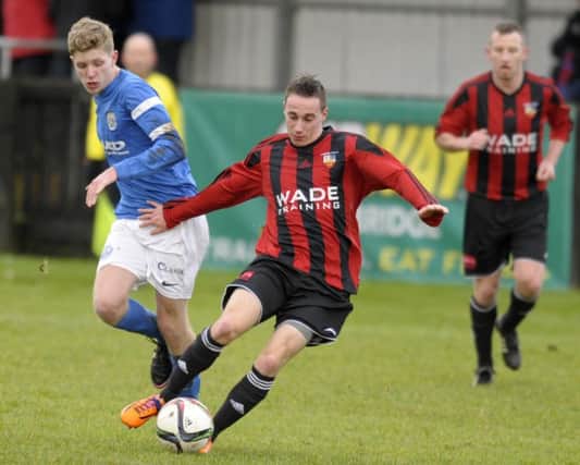 Banbridge Town's Ryan Gourley shields the ball from Limavady United's Conor Harkin. INBL1605-247PB